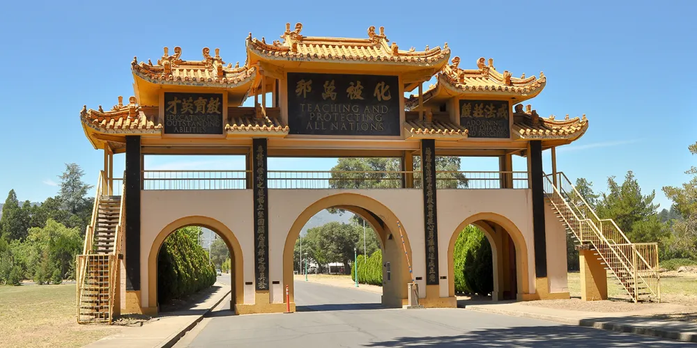 Golden entrance gateway at the City of Ten Thousand Buddhas near Ukiah
